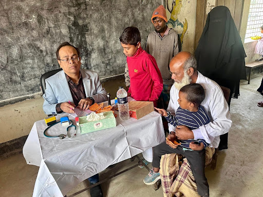 Doctor checking up the patient in the Medical Camp held by Ongshi in Bangladesh